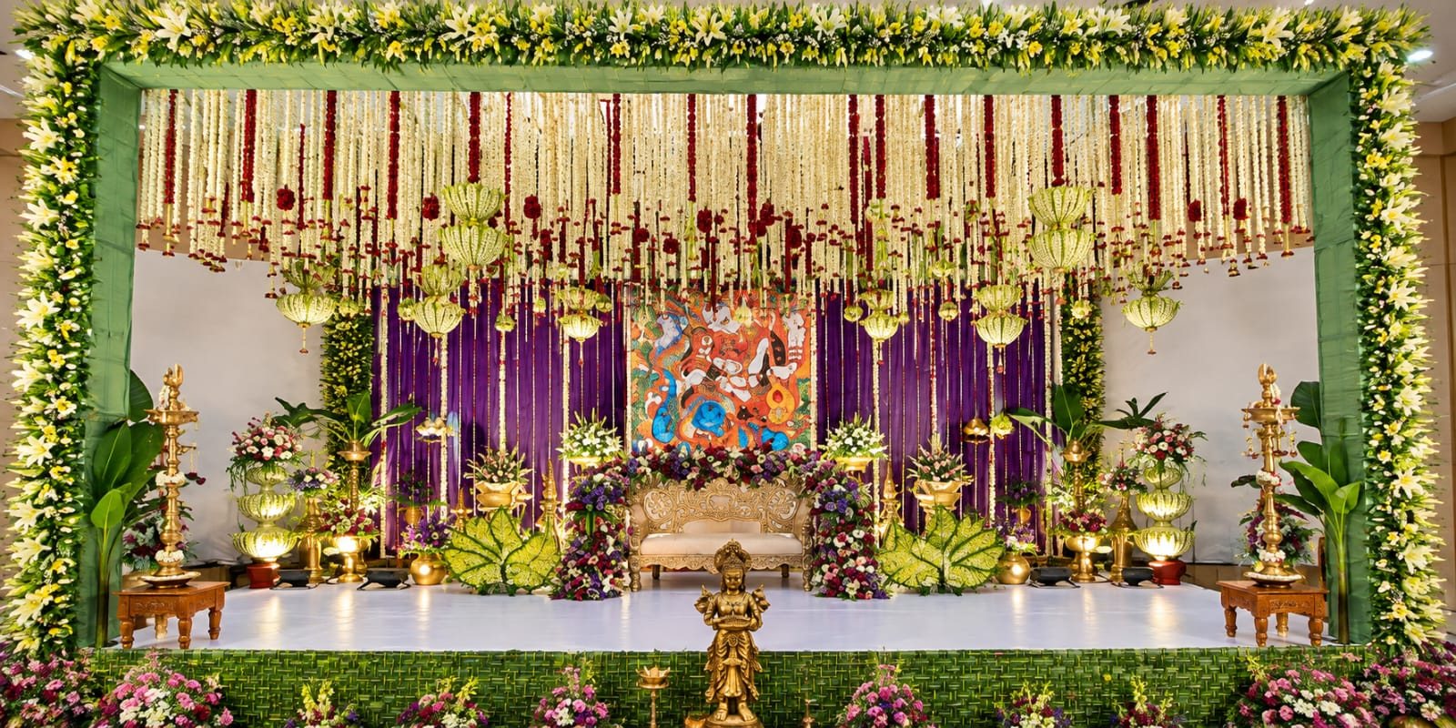 Stage framed by green garlands and flowers